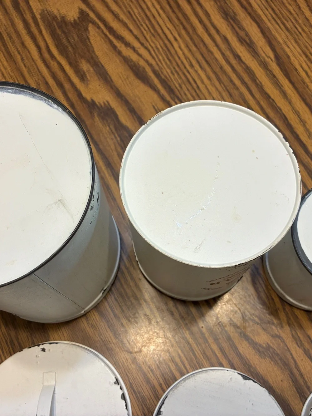 white metal canister set features a distressed farmhouse design 